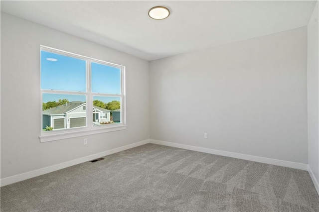 carpeted spare room with baseboards