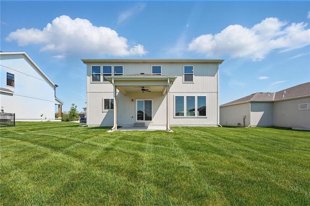 back of property featuring ceiling fan, a patio, and a yard