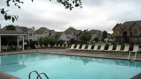 community pool with fence and a residential view