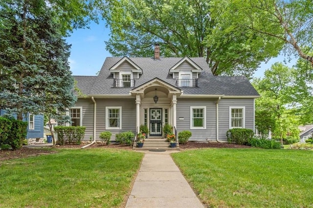 6445 Main St, Kansas City, MO 64113 - cape cod home featuring a front yard, a chimney, and roof with shingles