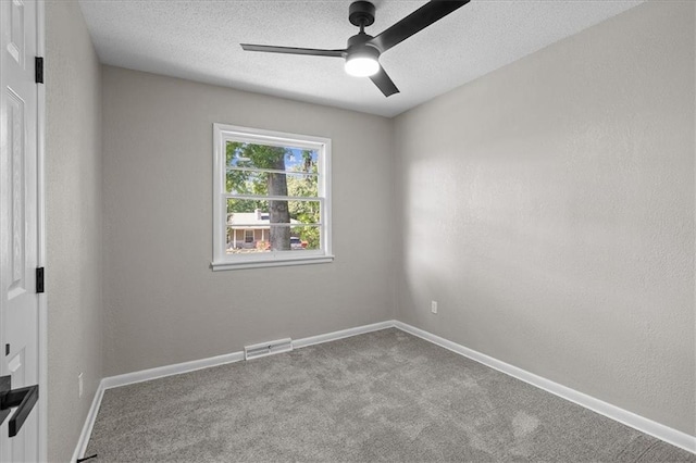carpeted empty room with a ceiling fan, a textured ceiling, and baseboards