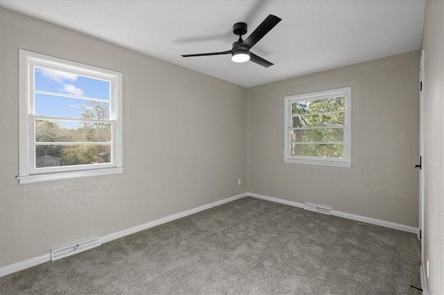 empty room featuring carpet, a ceiling fan, and baseboards