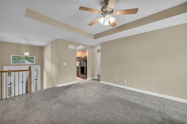 spare room with ceiling fan, arched walkways, baseboards, carpet, and a textured ceiling