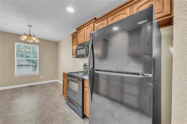 kitchen featuring black appliances, a chandelier, a textured ceiling, pendant lighting, and baseboards