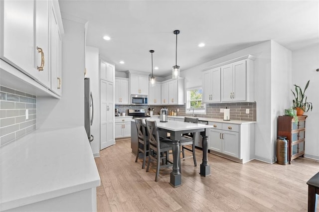 19623 W 196th Ter, Spring Hill, KS 66083 - kitchen with stainless steel appliances, decorative backsplash, light countertops, and recessed lighting