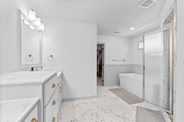19623 W 196th Ter, Spring Hill, KS 66083 - bathroom featuring vanity, a soaking tub, a walk in closet, marble finish floors, and a shower stall