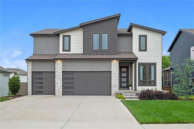 15932 W 171st Ter, Olathe, KS 66062 - modern home with stone siding, a garage, driveway, a front lawn, and stucco siding