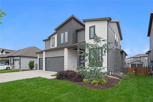 15932 W 171st Ter, Olathe, KS 66062 - view of front of property featuring driveway, an attached garage, stucco siding, and central AC unit