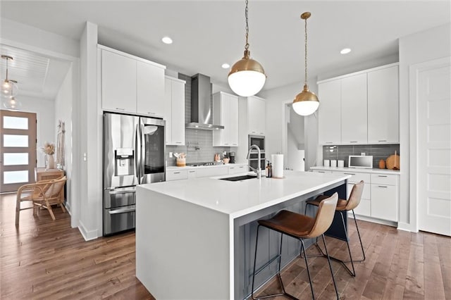 15932 W 171st Ter, Olathe, KS 66062 - kitchen featuring appliances with stainless steel finishes, a sink, wall chimney exhaust hood, dark wood-style flooring, and recessed lighting