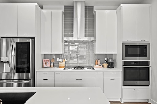 15932 W 171st Ter, Olathe, KS 66062 - kitchen with appliances with stainless steel finishes, wall chimney exhaust hood, light countertops, and decorative backsplash