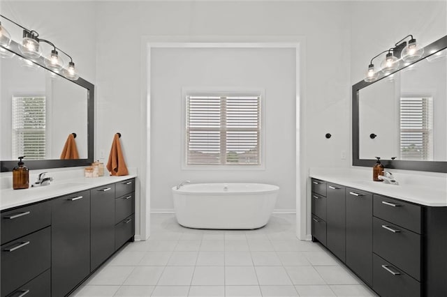 15932 W 171st Ter, Olathe, KS 66062 - bathroom featuring baseboards, two vanities, and a freestanding bath