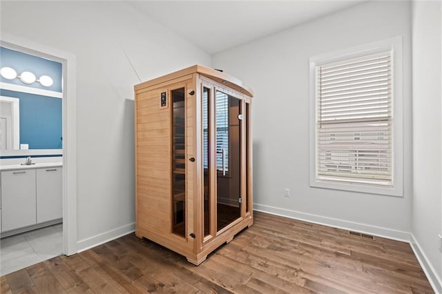15932 W 171st Ter, Olathe, KS 66062 - unfurnished bedroom featuring a sink, wood finished floors, baseboards, and ensuite bath
