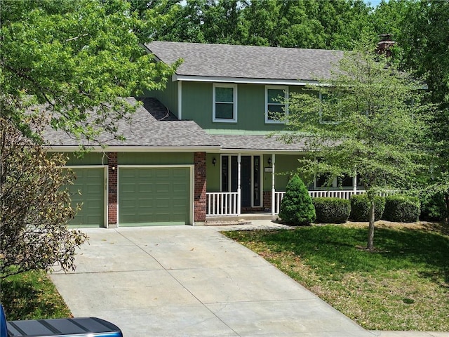 102 Willow Pt, Lansing, KS 66043 - view of front of home featuring covered porch, brick siding, a garage, driveway, and a shingled roof