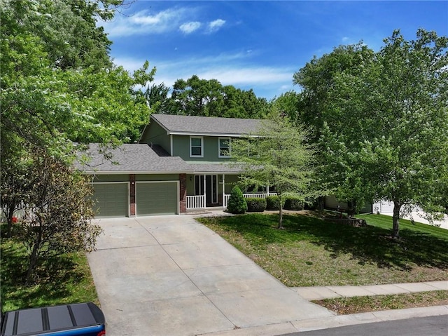 102 Willow Pt, Lansing, KS 66043 - traditional-style house with a front lawn, an attached garage, driveway, and brick siding