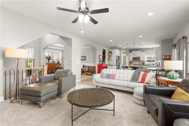 16966 S Durango St, Olathe, KS 66062 - living area featuring recessed lighting, a ceiling fan, arched walkways, light colored carpet, and baseboards
