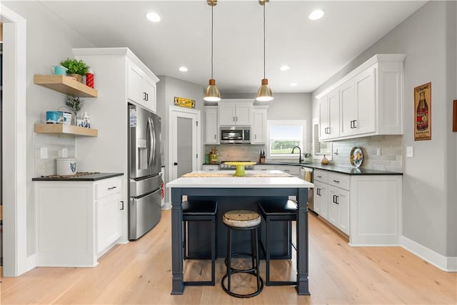 16966 S Durango St, Olathe, KS 66062 - kitchen with stainless steel appliances, light wood-style floors, backsplash, and recessed lighting