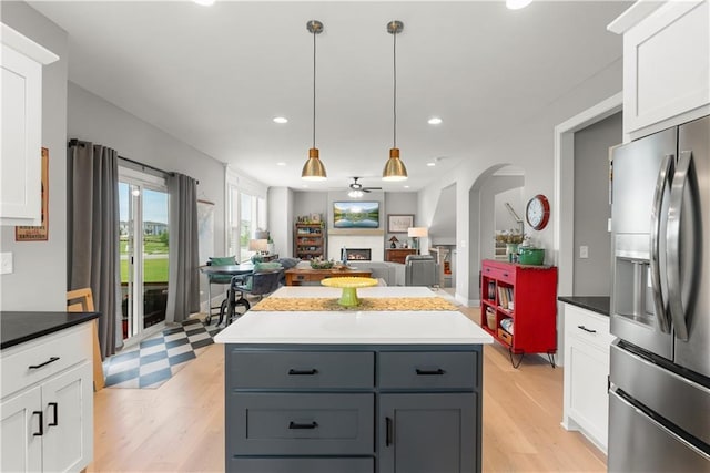 16966 S Durango St, Olathe, KS 66062 - kitchen with stainless steel fridge with ice dispenser, a ceiling fan, arched walkways, white cabinetry, and recessed lighting