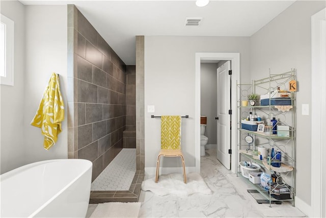 16966 S Durango St, Olathe, KS 66062 - full bathroom with marble look tile flooring, toilet, a freestanding tub, walk in shower, and baseboards