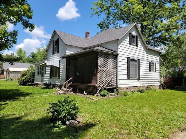 111 S Wall St, Leeton, MO 64761 - view of side of home featuring roof with shingles, a chimney, a yard, and a sunroom