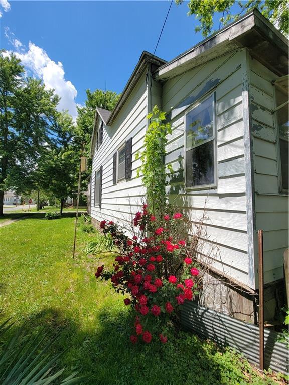 111 S Wall St, Leeton, MO 64761 - view of property exterior with a lawn