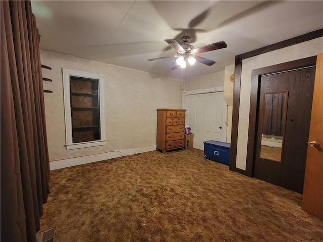 111 S Wall St, Leeton, MO 64761 - unfurnished bedroom with carpet floors, a ceiling fan, two closets, and baseboards