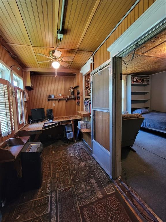 111 S Wall St, Leeton, MO 64761 - office featuring wooden walls and carpet