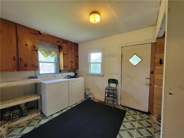111 S Wall St, Leeton, MO 64761 - washroom featuring independent washer and dryer, cabinet space, and tile patterned floors