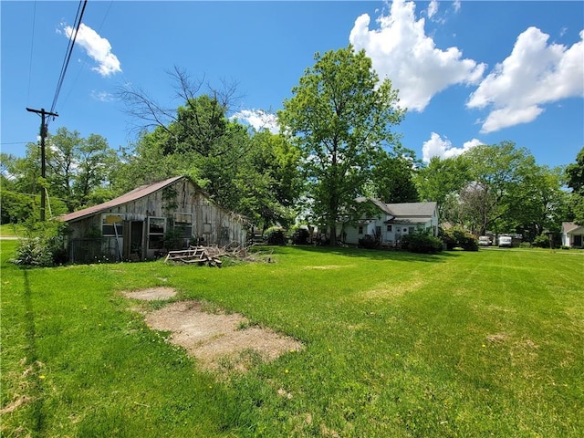 111 S Wall St, Leeton, MO 64761 - view of grassy yard featuring a barn and an outbuilding