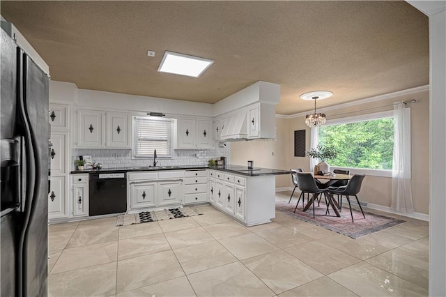2532 N 73rd St, Kansas City, KS 66109 - kitchen featuring black appliances, dark countertops, a sink, backsplash, and a chandelier