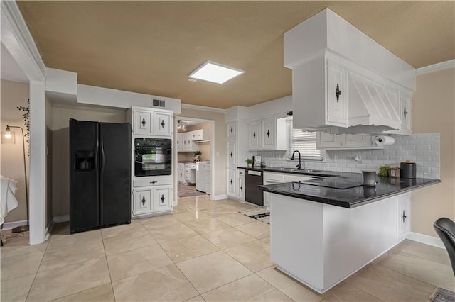 2532 N 73rd St, Kansas City, KS 66109 - kitchen with black appliances, a peninsula, dark countertops, backsplash, and a sink