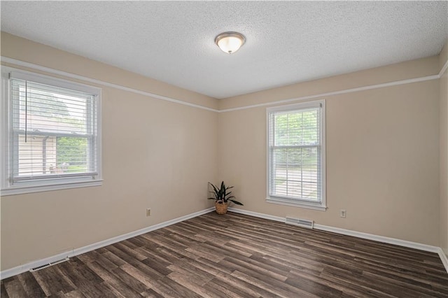 2532 N 73rd St, Kansas City, KS 66109 - unfurnished room featuring dark wood-style flooring, a textured ceiling, and baseboards