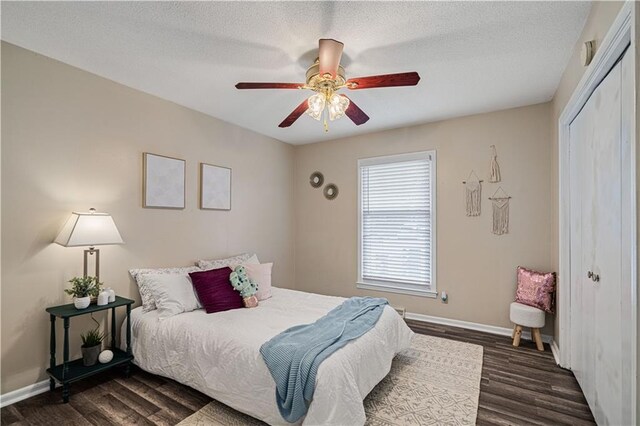 2532 N 73rd St, Kansas City, KS 66109 - bedroom with dark wood-style flooring, a closet, baseboards, a ceiling fan, and a textured ceiling