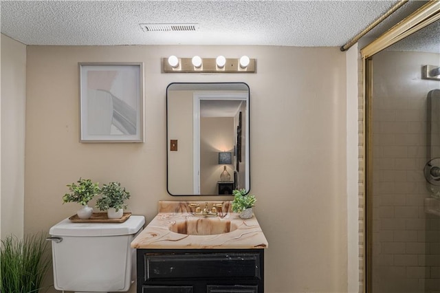 2532 N 73rd St, Kansas City, KS 66109 - bathroom with a textured ceiling, vanity, toilet, and a tile shower
