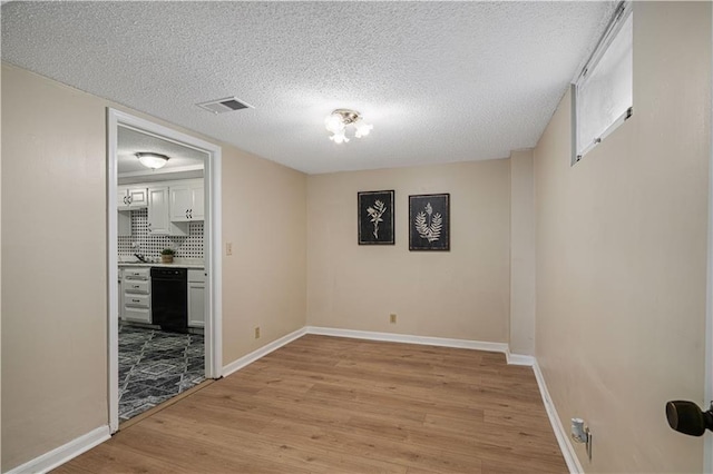 2532 N 73rd St, Kansas City, KS 66109 - unfurnished room with light wood-style flooring, a textured ceiling, and baseboards