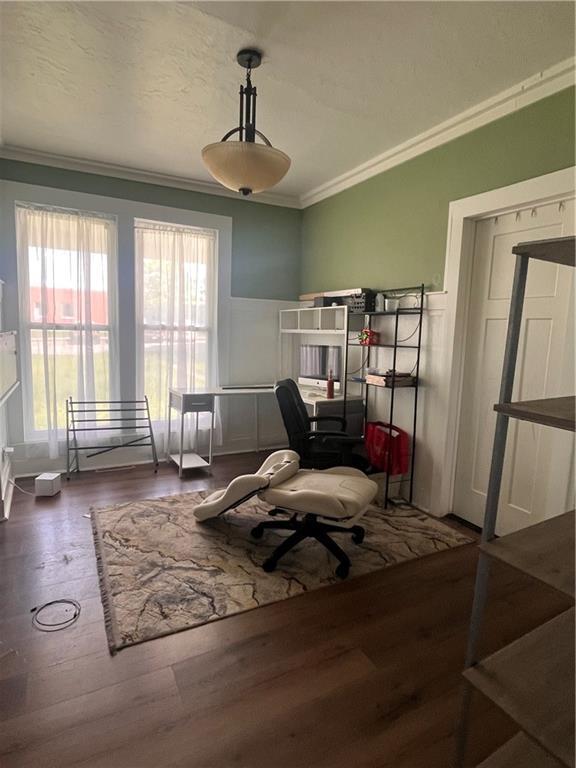 sitting room featuring ornamental molding, wood finished floors, wainscoting, a decorative wall, and an office area
