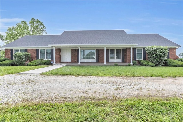 28210 Hedge Ln, Paola, KS 66071 - view of front facade featuring a front yard and brick siding