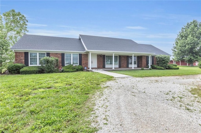 28210 Hedge Ln, Paola, KS 66071 - view of front of property featuring a front yard, covered porch, brick siding, and driveway