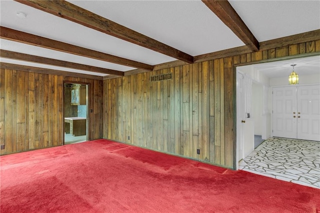 28210 Hedge Ln, Paola, KS 66071 - carpeted spare room featuring wood walls, beamed ceiling, a chandelier, and a smoke detector