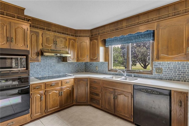 28210 Hedge Ln, Paola, KS 66071 - kitchen with black appliances, a sink, under cabinet range hood, light countertops, and tasteful backsplash