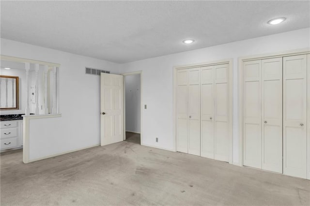 28210 Hedge Ln, Paola, KS 66071 - unfurnished bedroom with carpet flooring, two closets, recessed lighting, and baseboards