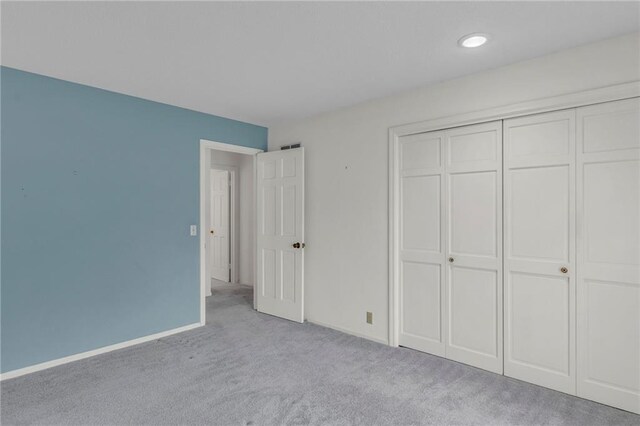28210 Hedge Ln, Paola, KS 66071 - unfurnished bedroom featuring carpet flooring, a closet, and baseboards