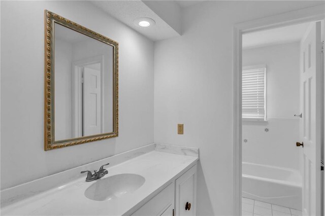 28210 Hedge Ln, Paola, KS 66071 - bathroom featuring vanity, a bathtub, and tile patterned floors