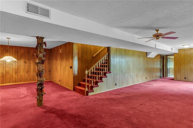 28210 Hedge Ln, Paola, KS 66071 - finished below grade area with wood walls, carpet floors, a textured ceiling, stairway, and a ceiling fan