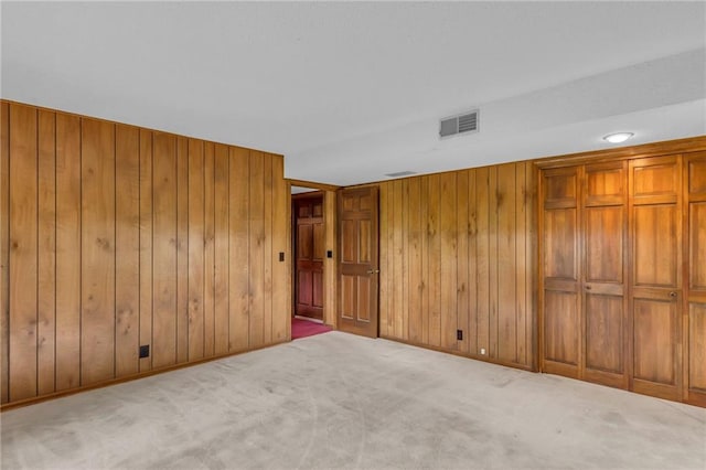 28210 Hedge Ln, Paola, KS 66071 - unfurnished bedroom featuring wood walls and carpet floors