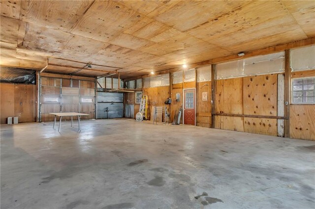 28210 Hedge Ln, Paola, KS 66071 - garage with wooden ceiling and wooden walls