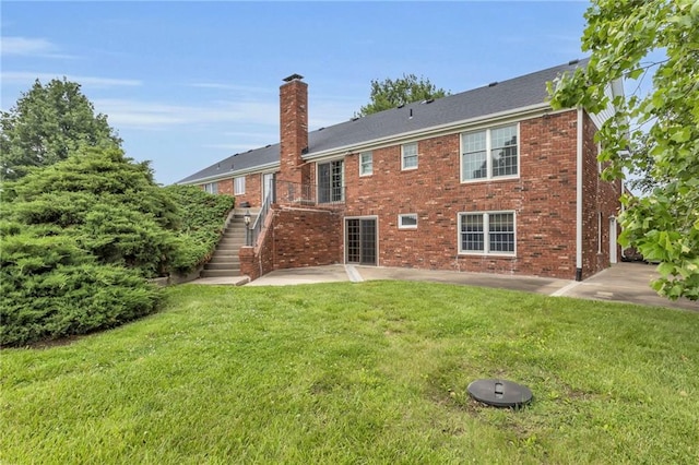 28210 Hedge Ln, Paola, KS 66071 - rear view of property with a chimney, a patio, brick siding, a yard, and stairs