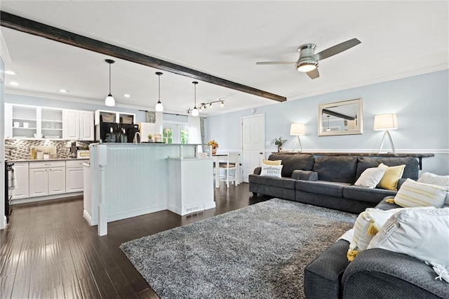 living room with ceiling fan, beam ceiling, dark wood-style flooring, ornamental molding, and recessed lighting