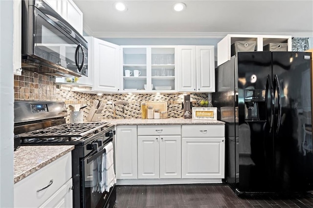 kitchen with black appliances, white cabinetry, glass insert cabinets, crown molding, and backsplash