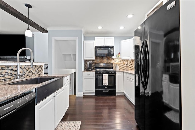 kitchen with black appliances, a sink, crown molding, tasteful backsplash, and white cabinets