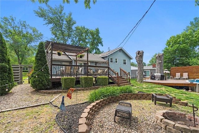 rear view of house featuring a deck, an outdoor fire pit, and a pergola